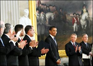 With a statue of Abraham Lincoln peering, President Barack Obama smiles in the Rotunda on Capitol Hill in Washington, Thursday, while attending a Congressional ceremony celebrating Abraham Lincoln's 200th birthday. From right are, Senate Minority Leader Mitch McConnell of Ky., Senate Majority Leader Harry Reid of Nev., the president, House minority Leader John Boehner of Ohio, and Rep. Jesse Jackson Jr., D-Ill.