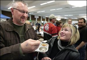 Slug: CTY cookoff29p   Date:  03282009        The Blade/Andy Morrison       Location: Toledo Caption: Scott Russ, Norwalk, and Dawn Dishong, Erie, MI., have a blast sampling the West Toledo Healthcare Center Italiano Chili at the 17th annual Chili Cookoff at the Stranahan Great Hall, Saturday, 03282009.    Summary: