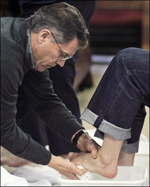 Len Greninger washes Cora Lind s feet during a Maundy Thursday service at St. Matthew s Episcopal Church in West Toledo.