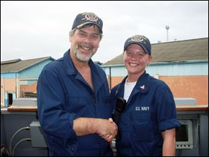 nbr MELISSA FOLEY    received 04/23/2009  handout photo    ***    NOT BLADE PHOTO     Melissa Foley shakes hands with Captain Richard Phillips aboard the USS Bainbridge after Captain Phillips of the merchant ship Alabama was rescued from Somali pirates.