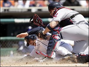 Detroit s Placido Polanco gets tagged out by the Indians  Kelly Shoppach while trying to score on a Miguel Cabrera single.