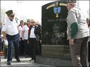 Stan Opferman, far left, Jennie Urban, Matt Urban s widow, and Richard  Perch surround the newly unveiled memorial to Lt. Col. Matt Louis Urban, who was awarded 29 medals, including the Medal of Honor, for his service in World War II. Yesterday s ceremony was in Veterans Park in Monroe. 