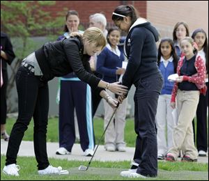 CTY farr12p 05/11/09  The Blade/Dave Zapotosky Caption: Professional golfer Paula Creamer, defending champion of the  Jamie Farr Owens Corning Classic,  shows Alexia Franco, 13, a student at Queen of Apostles School in Toledo, Ohio, how to hold a golf club during a visit to the school, Monday, May 11, 2009.