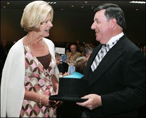 Lynne Guran, left, of WTVG-Channel 13, shares a moment with Richard Eppstein, president of the Better Business Bureau of Northwest Ohio, which observed its 90th anniversary yesterday.