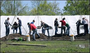 Eighth-grade students from Seneca East participate in a hands-on history lesson by digging at a former Civil War military prison.