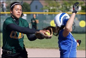 Springfield s Brittany Richberg, right, is tagged out by Clay s Eryn Simon. Simon helped the Eagles  offense with a home run.