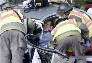 Toledo firefighters remove an unidentified driver who was pinned in one of three cars involved in a crash in the 3700 block of Heatherdowns Boulevard about 7:30 yesterday morning. The driver of the second vehicle, a woman, also had to be extricated by emergency personnel. Both were taken to the University of Toledo Medical Center, formerly the Medical College of Ohio Hospital, with serious injuries. The third driver, a woman, also was taken to an area hospital. The crash remains under investigation. Identities of the injured were unavailable.