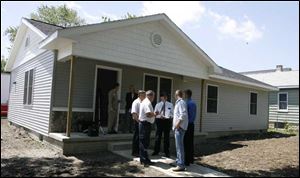 The new home for Julie Payne and her children, Hunter, 4, Jordan, 7, and Kayle, 10, is a ranch-style house at 1748 Oak. St.