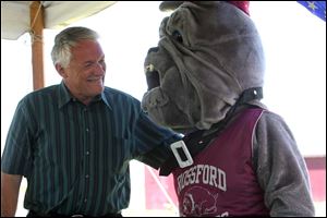 Slug: CTY rossford29p                Date 6/28/2009           The Blade/ Amy E. Voigt              Location: Rossford, Ohio NOTE TO DESK: Randy gardner was the only official at event.  CAPTION:  Brian Hughes, President of the Rossford School Board, left, chats with the Rossford Bulldog Mascot, who is being played by school board member Jackie Brown, right, during the groundbreaking for the first phase of Rossford School District's $14 million athletic complex.