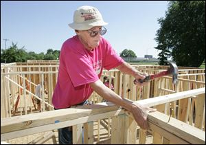 NBRE habitat01p  06/26/09  The Blade/Dave Zapotosky Caption:  Bill Forsee of Christ Presbyterian Church in Toledo hammers nails at a Habitat for Humanity build on Ansonia St. in Oregon, Ohio, Friday, June 26, 2009.  Two homes were being constructed by a large group of volunteers including some from five are religious congregations, the United Way Women's Initiative, and the National Association of Women in Construction (NAWIC), Toledo Chapter.   Summary: Habitat for Humanity build in Oregon.