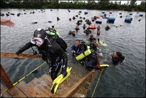 Slug: CTY gilboa19p Date:   07172009       The Blade/Andy Morrison       Location: Gilboa    Caption: Divers climb back on dry land after trying to set the world record for most divers submerged at Gilboa Quarry, Saturday, 07182009.