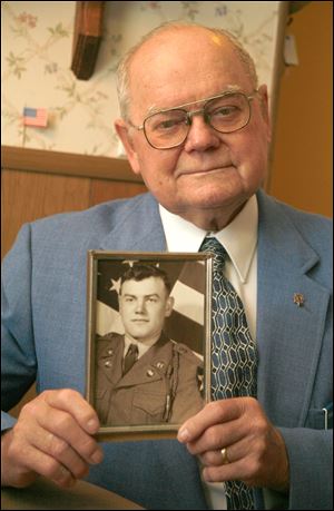 Rolland Desautels of Toledo shows a picture of his brother Richard, who joined the Army at 17 and was captured during the Korean War. He remains missing.