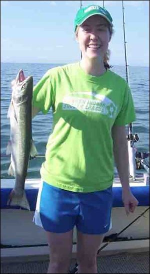 Annie McLaren ofIndianapolis shows off a 22-inch steelhead trout she took on a walleye trolling trip near West Sister Island.