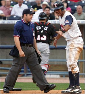 Wilkin Ramirez, right, argues with the home plate umpire after being called out in the third.