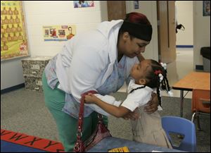 CTY school01p  Tiffany Bailey, left, gives her daughter Aseantia (cq) Cavitt (cq), 5, a hug before she goes to work and Aseantia starts kindergarten.  The first day of kindergarten for students at Sherman Elementary School in Toledo, Ohio on August 31, 2009. Also, for Ryan Smith's 