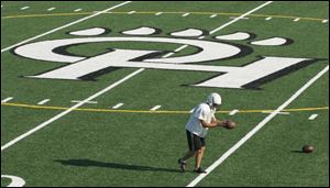 Michael Geiger works out on the new artificial turf at Ottawa Hills' stadium. Thesurface cost about $656,000. It will be used for football, soccer and field hockey.