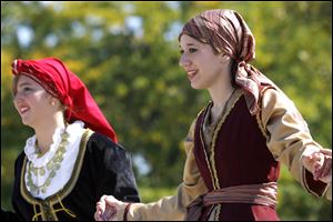 Slug: CTY greekfest13p                      Date 9/12/2009           The Blade/ Amy E. Voigt           Location: Toledo, Ohio  CAPTION:  Dionna Damaskos, left, and Kristin Zink,right, perform a Greek dance with the Olympians dance troupe during the 39th annual Greek-American Festival on September 12, 2009 at Holy Trinity Cathedral.