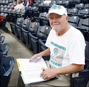 Behind home plate you will find 'Whitey' Hafner, notebook open, jotting notes about players.