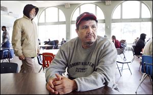 Alejandro Dominguez, 41, of East Toledo, used to work in construction but was sidelined by a back injury. ‘I just put my faith in God,' he said yesterday at Cherry Street Ministries.   