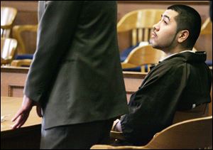 Enrique Martinez listens to the proceedings in Lucas County Common Pleas Court yesterday as a motion is made to vacate his guilty plea. Martinez says he misunderstood the details of his plea deal, believing he was going to jail for only 15 years, instead of the possibility of life behind bars he faces now.