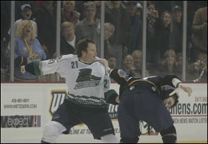 Florida's Steve McJannet, left, and Toledo's Justin Hodgman square off Saturday night in the Lucas County Arena's first fight.