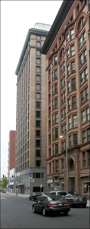 The Spitzer Building, foreground, on Madison Avenue is open. The Nicholas Building, background, closed last month.