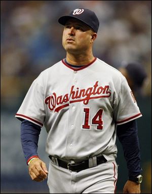 In this June 14, 2009 file photo, Washington Nationals manager Manny Acta walks back to the dugout after taking left-handed pitcher Ron Villone out of the baseball game in the eighth inning against the Tampa Bay Rays in St. Petersburg, Fla. The Cleveland Indians have hired Manny Acta as their manager. Team spokesman Bart Swain said Sunday that Acta has signed a three-year contract with a club option for 2013. 