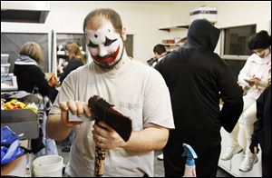 Andy Johnson of Walbridge prepares his ax for a night of scares at TerrorTown, where the budget for such props has been cut.