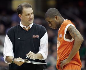 Dan Dakich discusses strategy with guard Brian Moten during the Falcons game with Ohio University in March, 2007, during the MAC tourney in Cleveland.