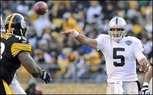 Oakland quarterback Bruce Gradkowski throws a pass against the Pittsburgh Steelers. The University of Toledo product is 2-1 as the starting QB for the Raiders.