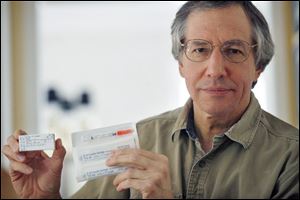 Larry Friedman displays vials of the insulin drug Vetsulin. Mr. Friedman has filed suit against the drug's manufacturer, Schering-Plough Animal Health, in U.S. District Court, Toledo, alleging negligence, violation of consumer sales practice, breach of warranty, and defective product.