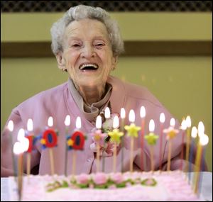 Freda Sackett is aglow as she prepares to blow out her candles. The second of 10 children, she is the only one still living.