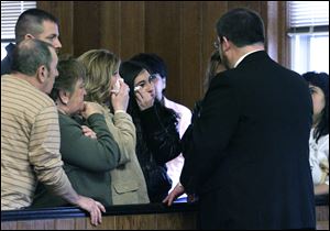 Family members of Todd Helms meet with his attorney, Dean Henry, after Helms is sentenced by Judge Barbara Ansted. 