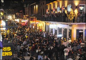 New Orleans fans flock to Bourbon Street to celebrate the Saints' 31-28 victory over the Minnesota Vikings in the NFC title game.