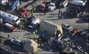 Emergency personnel and vehicles massed at the site. Crews were to spend all night going through debris from the explosion to check for more victims.