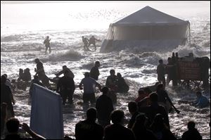 Spectators scramble after giant rogue waves hit the beach during the Mavericks surfing contest at Pillar Point, Calif., near Half Moon Bay. At least 15 people were hurt seriously.