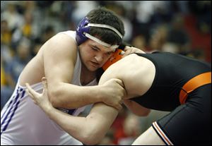 Swanton's Derek Johnson hangs on to beat Liberty Center's Zane Crall to claim the 215-pound district crown.