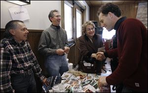 At Wildwood Metropark's Seed Swap, volunteers Bob Avery, from left, and Dale Theis chat with Rep. Marcy Kaptur (D., Toledo) and Michael Szuberla of Toledo GROWS.