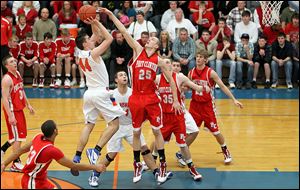 Port Clinton's Ryan HIcks tries to block a shot by of Edison's Ryan Reber. Hicks, a 6-foot-6 senior,
averages 16.4 points and 10.3 rebounds and was named Sandusky Bay Conference's outstanding performer. 