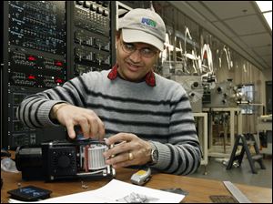 Graduate student Lila Dahal modifies equipment at the University of Toledo's Clean and Alternative
Energy Incubator. UT has raised $37 million for solar research in the last three years.