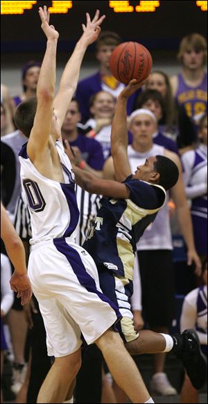 Cheatham Norrils of St. John's puts up a shot against Massillon Jackson's Mark Henniger in Saturday night's regional final.