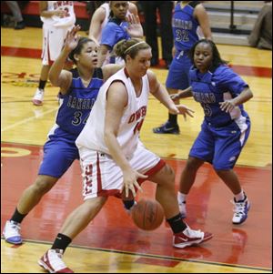 Brittany Darling drives past two Lakeland players. The 6-foot-5-inch Genoa graduate set Owens records for blocked shots in a season and per-game rebounds.