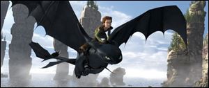 Hiccup, voiced by Jay Baruchel, rides Toothless in a scene from 'How to Train Your Dragon.'