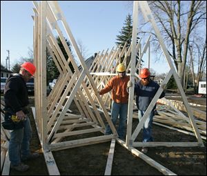 CTY build28p Frank Psurny, left; Don Dotson, and Jack Shapard (cq), all, of Swanton,  working on a truss. The Dotson Company [419.877.5776] is constructing housing for Mercy Outreach Industries IV, Inc. at 6934 Brint in Sylvania, Ohio on  Wednesday, March 24, 2010. They expect to be finished in late 2010. Jetta Fraser/Toledo Blade