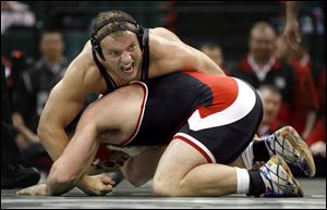 Central Catholic's Jake Henderson tries to control Wapakoneta's Logan Erb in the Division II 215-pound state final. It was the only loss of the season for Henderson, who fell 3-2 insudden-death overtime and finished the season with a 49-1 record.