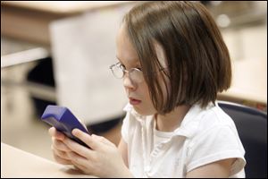 Ottawa River Elementary school student Jasmyne Ramasocky uses an electronic clicker to answer a question during class.