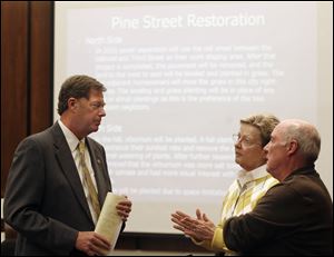 Perrysburg City Administrator John Alexander, left, talks with Judy and Richard Emmons about upcoming street closures.