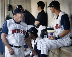 Larry Parrish, left, talks with Ryan Strieby. Parrish managed his 1,000th game with the Hens to put him second in team history.