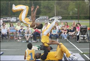 Slug: CTY acrobats03p                               Date 5/02/2010 Toledo Blade/Amy E. Voigt                Location: Toledo, Ohio  CAPTION:  Drashun(cq) Wilson, with The Chicago Boyz Acrobatic Team,flips over his teammates in an acrobatic feat  in honor of the holiday Lag B'Omer at the Jewish Community Center on Sunday on May 2, 2010. The event was sponsored by the Chabad House of Toledo and The Friendship Circle.