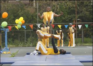 Slug: CTY acrobats03p                               Date 5/02/2010 Toledo Blade/Amy E. Voigt                Location: Toledo, Ohio  CAPTION:  Deshawn McClinton, with The Chicago Boyz Acrobatic Team, flips over his teammates in an acrobatic feat in honor of the holiday Lag B'Omer at the Jewish Community Center on Sunday on May 2, 2010. The event was sponsored by the Chabad House of Toledo and The Friendship Circle.